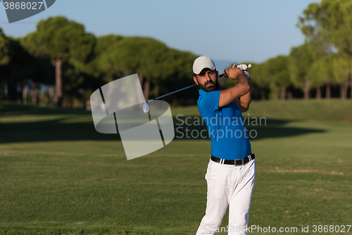 Image of pro golfer hitting a sand bunker shot