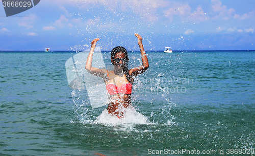 Image of Girl splashing seawater