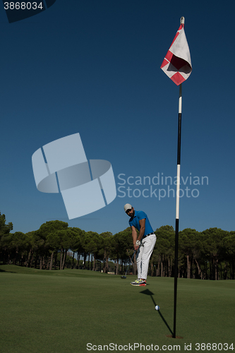 Image of golf player hitting shot at sunny day