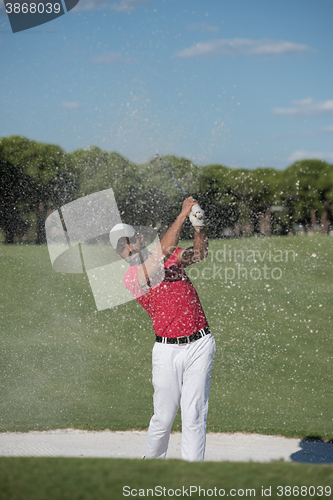 Image of golfer hitting a sand bunker shot