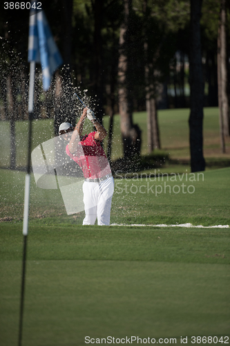 Image of golfer hitting a sand bunker shot