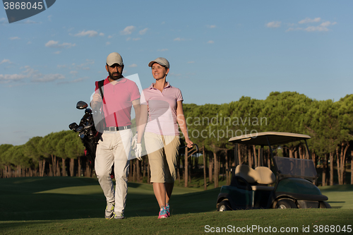 Image of couple walking on golf course