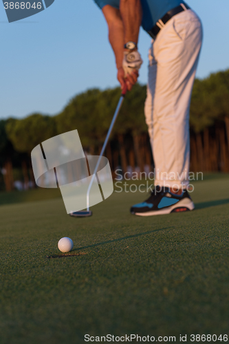 Image of golfer  hitting shot at golf course