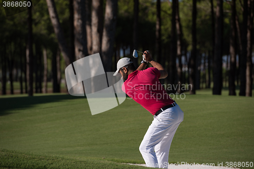 Image of golfer hitting a sand bunker shot