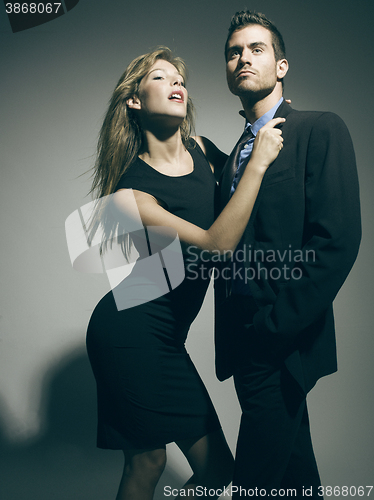 Image of elegant fashionable couple in black suit and dress