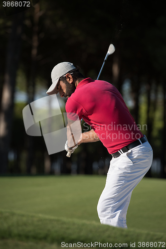 Image of golfer hitting a sand bunker shot