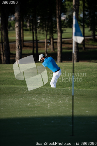 Image of pro golfer hitting a sand bunker shot