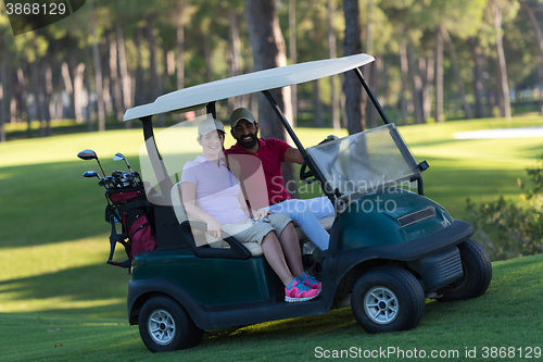 Image of couple in buggy on golf course