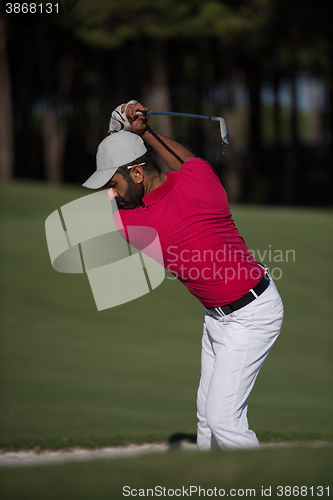 Image of golfer hitting a sand bunker shot