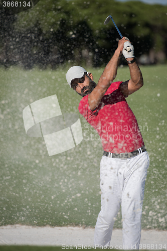 Image of golfer hitting a sand bunker shot