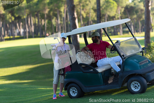 Image of couple in buggy on golf course