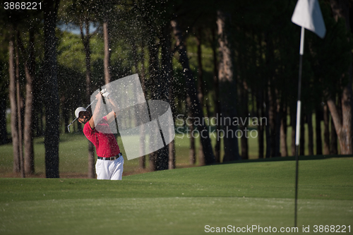 Image of golfer hitting a sand bunker shot