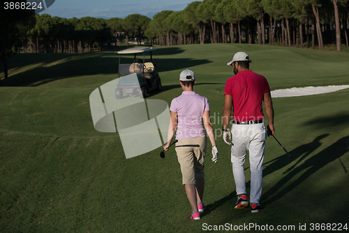 Image of couple walking on golf course