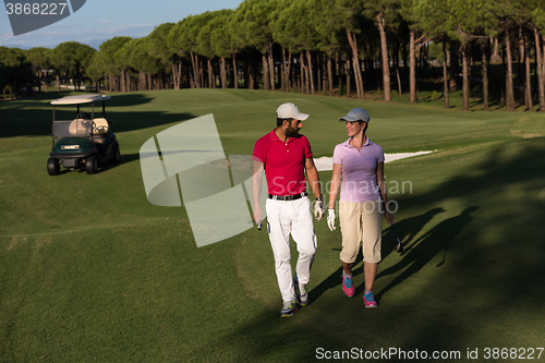 Image of couple walking on golf course