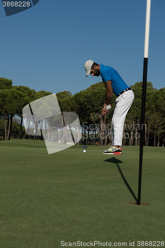 Image of golf player hitting shot at sunny day