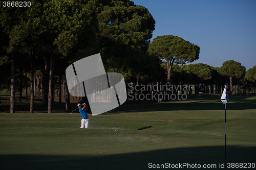 Image of pro golfer hitting a sand bunker shot