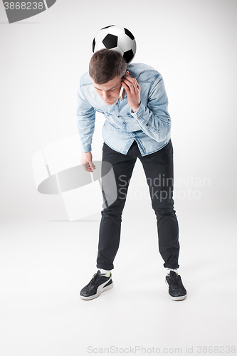 Image of The portrait of fan with ball, holding phone on white background
