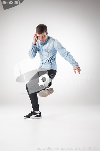 Image of The portrait of fan with ball, holding phone on white background