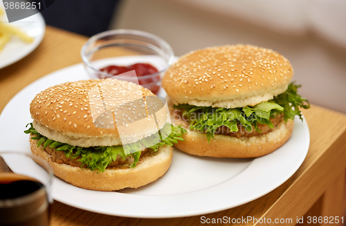 Image of close up of two hamburgers on table