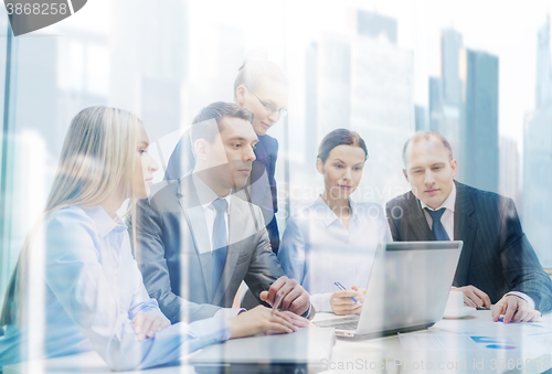 Image of business team with laptop having discussion