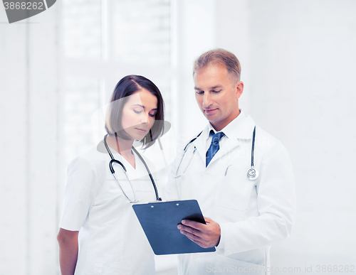 Image of two doctors writing prescription