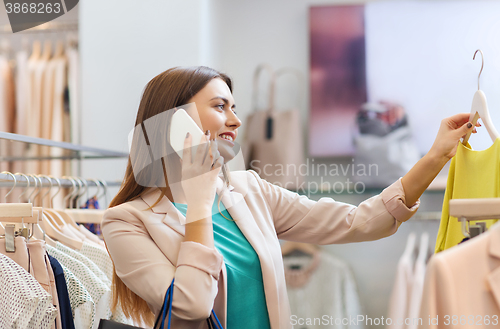 Image of woman calling on smartphone at clothing store