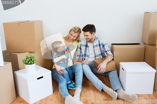 Image of happy family with boxes moving to new home