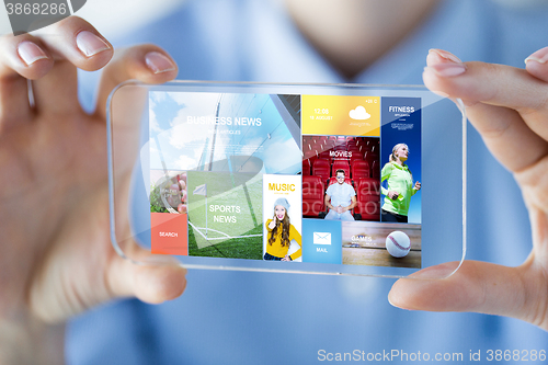 Image of close up of woman with transparent smartphone