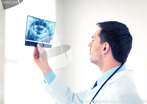 Image of male doctor or dentist looking at x-ray