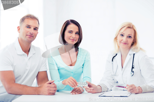 Image of doctor giving pills to patients