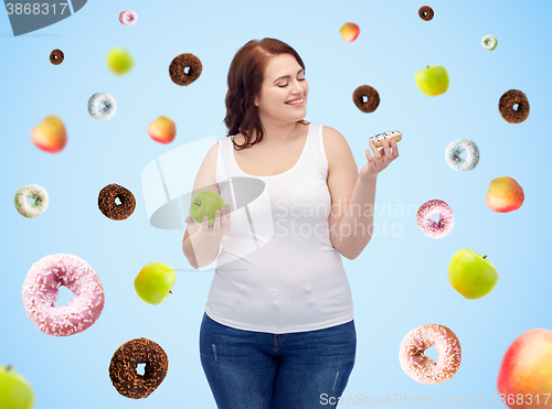 Image of happy plus size woman choosing apple or donut