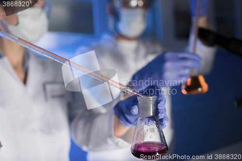 Image of close up of scientists making test in lab