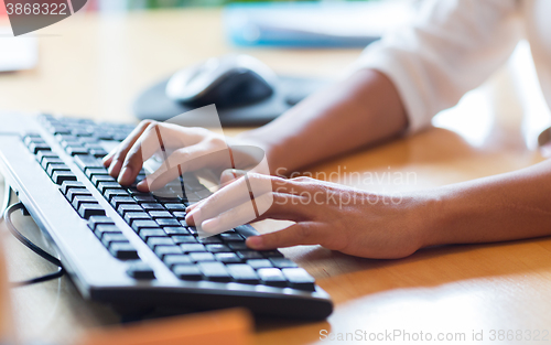 Image of close up of female hands typing on keyboard