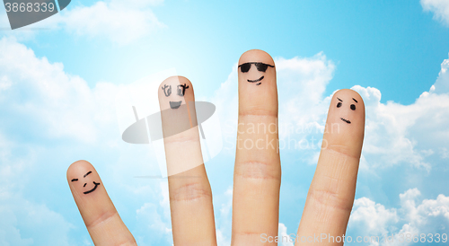 Image of close up of four fingers family with smiley faces