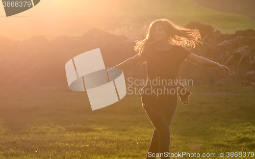 Image of Girl jump against beautiful sunset in forest