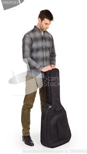 Image of Musican with acoustic guitar in bag