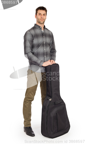 Image of Musican with acoustic guitar in bag