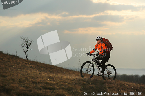 Image of Man cyclist with backpack riding the bicycle