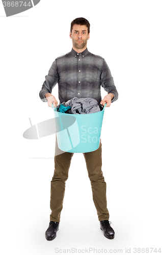 Image of Full length portrait of a young man holding a laundry basket