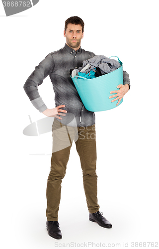 Image of Full length portrait of a young man holding a laundry basket