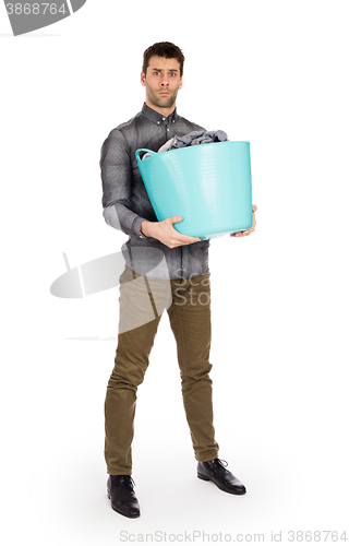 Image of Full length portrait of a young man holding a laundry basket