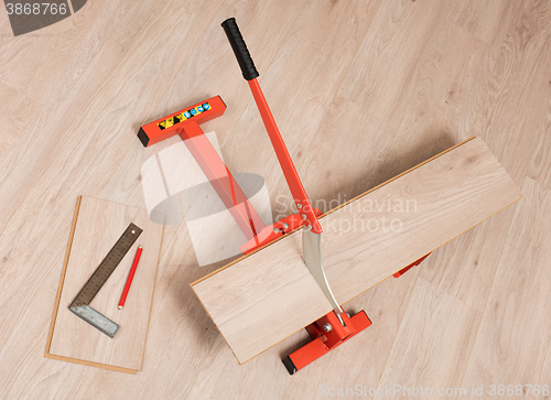 Image of Red tool for cutting laminate