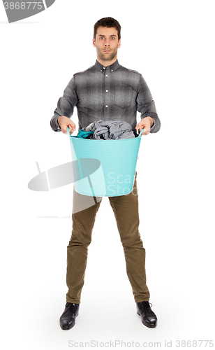 Image of Full length portrait of a young man holding a laundry basket