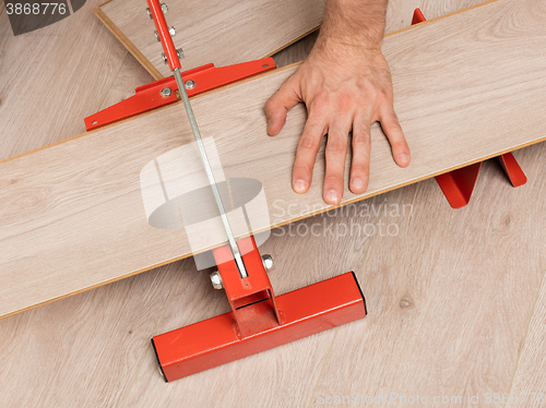 Image of Red tool for cutting laminate