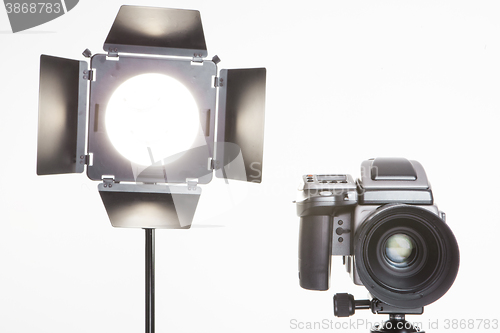 Image of medium format  proffesional camera and studio light with barn doors
