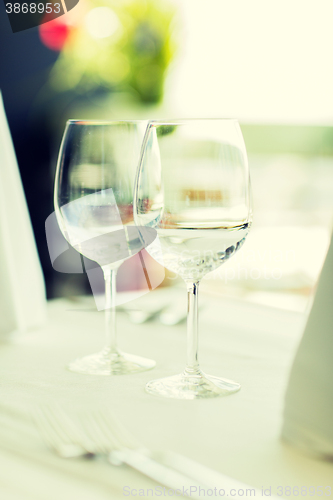 Image of close up of two wine glasses on restaurant table