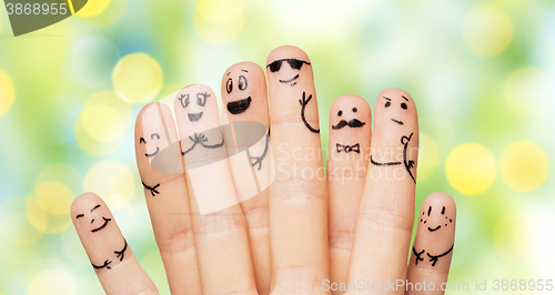 Image of close up of hands and fingers with smiley faces