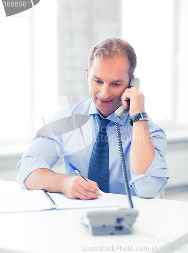 Image of handsome businessman talking on the phone