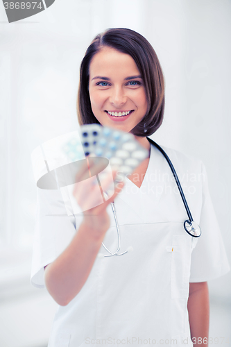 Image of doctor with blister packs of pills