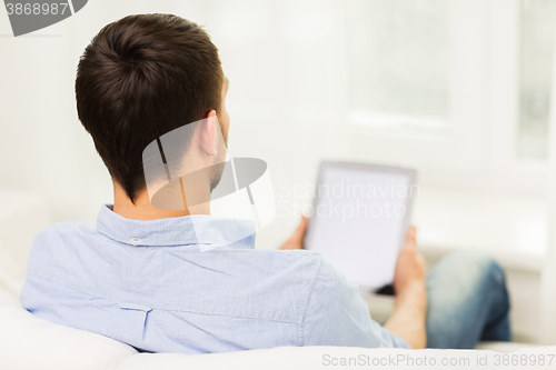 Image of close up of man working with tablet pc at home